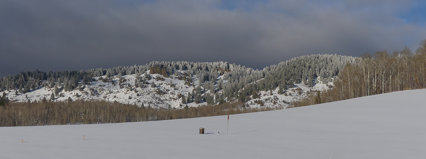 Snowy hill behind house